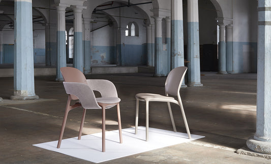 HUG 2384 designer chair collection featuring upholstered and moulded shell chairs displayed in a contemporary industrial interior.