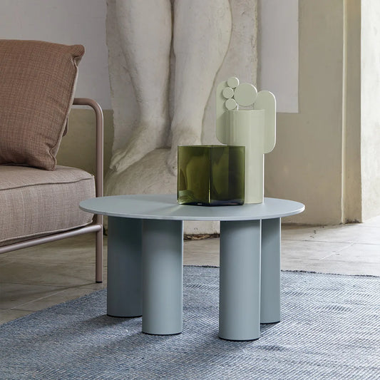 S•CAB Hyppo Ø70 cm outdoor coffee table in a sage green finish styled beside a lounge chair in a contemporary outdoor living space.