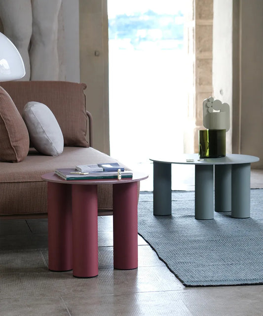 S•CAB Hyppo outdoor coffee tables in Ø50 cm and Ø70 cm sizes displayed together in terracotta and sage green finishes beside a contemporary sofa.