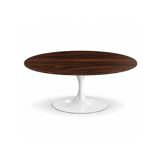 Italian oval ebony wood pedestal dining table with a white tulip base on a white background.