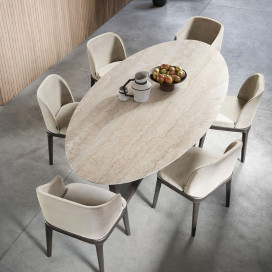 Italian oval travertine-effect ceramic dining table with six upholstered dining chairs viewed from above in a contemporary dining room.