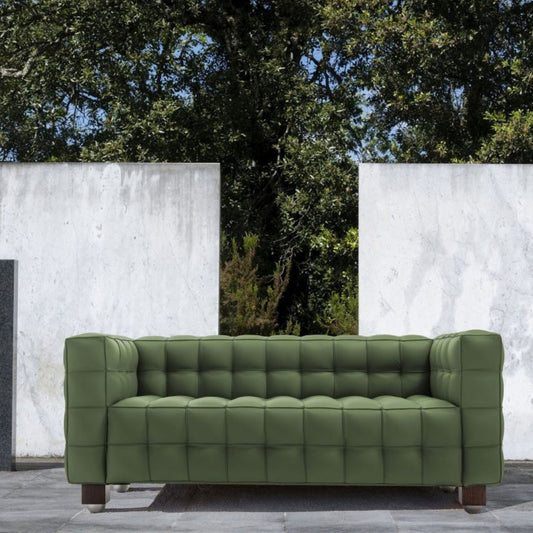 Olive green tufted leather cube sofa with deep square quilting and a minimalist geometric silhouette, inspired by iconic Italian modernist design, suitable for contemporary indoor and outdoor living spaces.