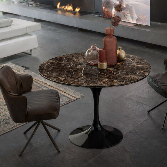 Round tulip table Saarinen style with Emperador marble top and black pedestal base in modern living room