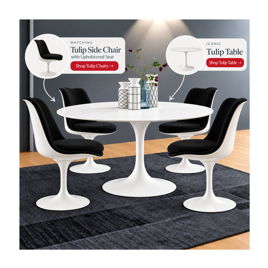 White Saarinen Tulip dining table paired with four black upholstered Tulip side chairs featuring sculptural pedestal bases in a contemporary mid-century modern dining room.