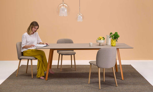 S•CAB Squid Hexagonal Dining Table with a wood-effect hexagonal tabletop and terracotta metal legs in a contemporary dining room setting.