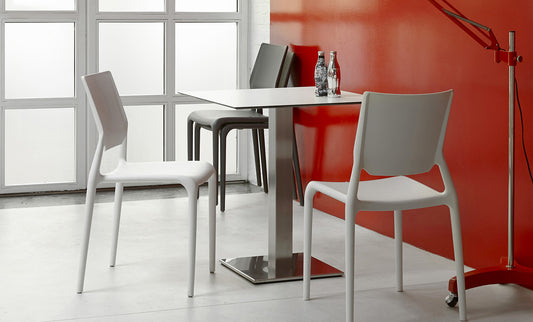 S•CAB Tiffany Bistro Table Base with a square tabletop paired with Tiffany chairs in a contemporary café and dining setting.