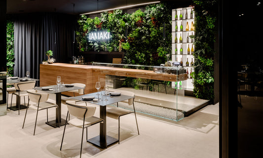 S•CAB Tiffany Bistro Table Base with square tabletops furnishing a contemporary restaurant interior with Tiffany chairs.
