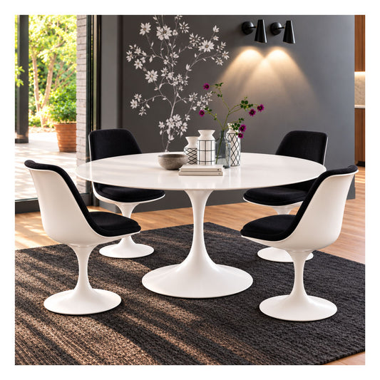 White round Eero Saarinen Tulip dining table with a white matte pedestal base paired with four black upholstered Tulip dining chairs featuring white shells in a modern dining room.