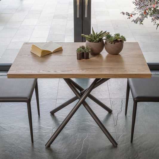Altacom Lotus convertible dining table top view showing wood surface and metal cross base