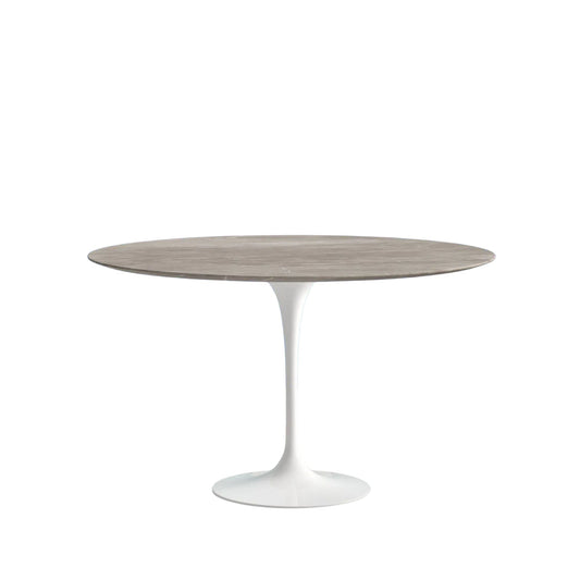 Round dining table with a wooden top and white base on a white background