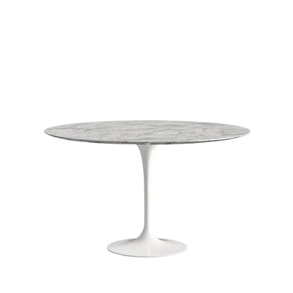 Round marble table with white base on a white background