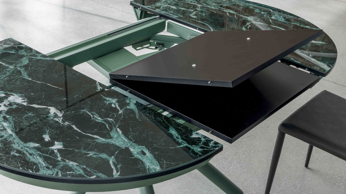 Helios transforming table by Altacom shown open with hidden extension mechanism and folding tabletop sections