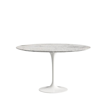 Round marble table with white pedestal base on a white background