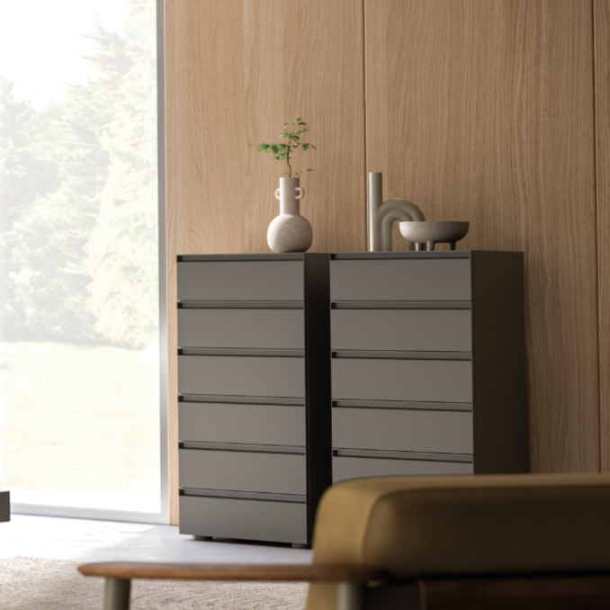 Modern bedroom with gray bed, nightstand, and dresser.