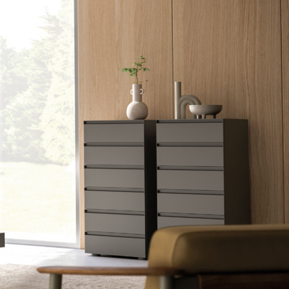 Modern bedroom with gray bed, nightstand, and dresser.