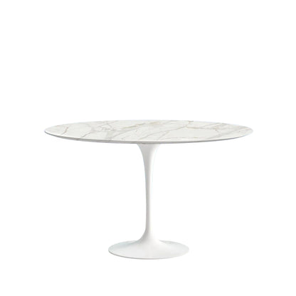 Round marble table with white pedestal base on a white background