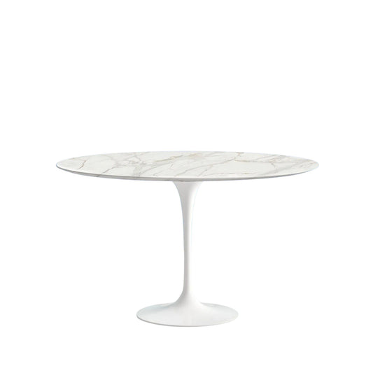 Round marble table with white pedestal base on a white background