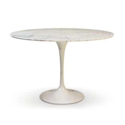 Round marble table with a white base on a white background