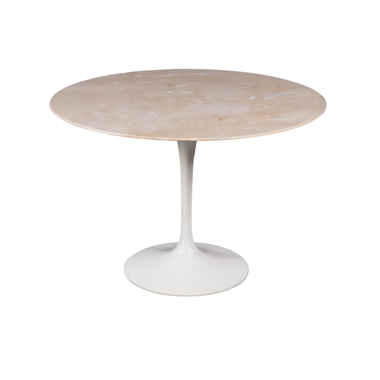 Round marble table with a white pedestal base on a white background