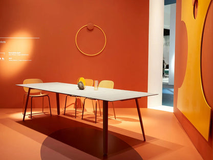 SCAB Squid modern Italian extendable dining table presented in a designer showroom with elegant seating, highlighting its slim profile and premium HPL tabletop for residential and contract interiors