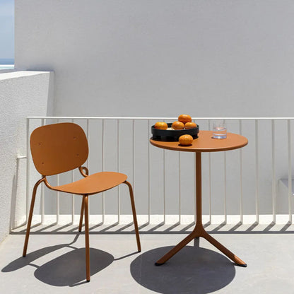 SCAB Tripè round outdoor side table with a terracotta aluminium pedestal base and matching tabletop, styled on a contemporary balcony for compact outdoor dining and café seating.