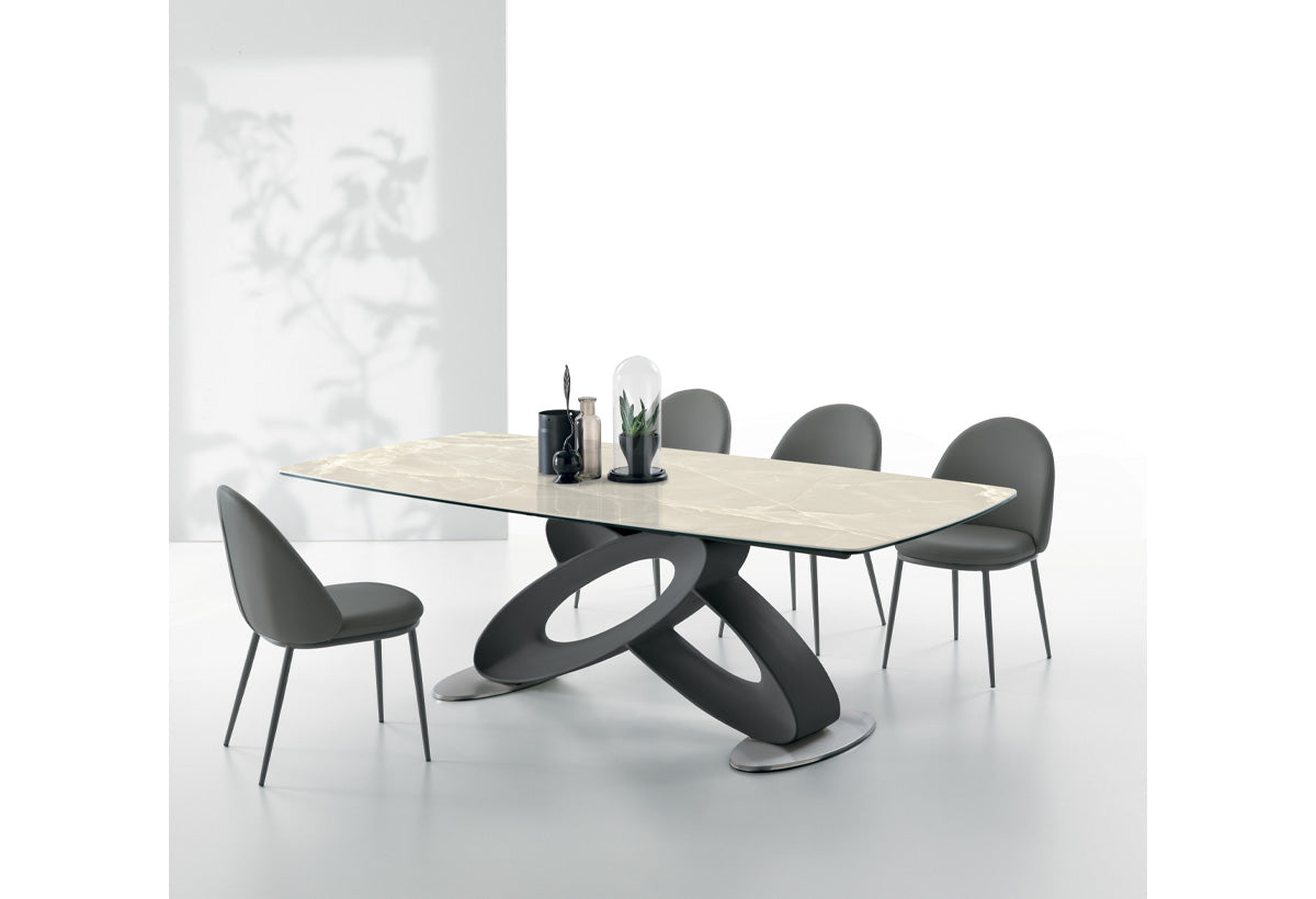 Target Point Eclipse Fixed Dining Table with a light porcelain stoneware barrel-shaped top and sculptural black base in a modern minimalist dining space.