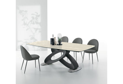 Target Point Eclipse Fixed Dining Table with a light porcelain stoneware barrel-shaped top and sculptural black base in a modern minimalist dining space.