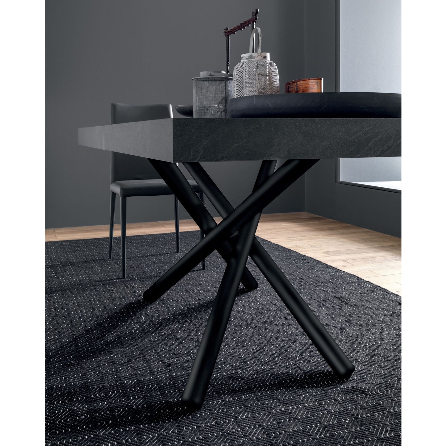 Altacom dining table with sculptural crossed metal base detail