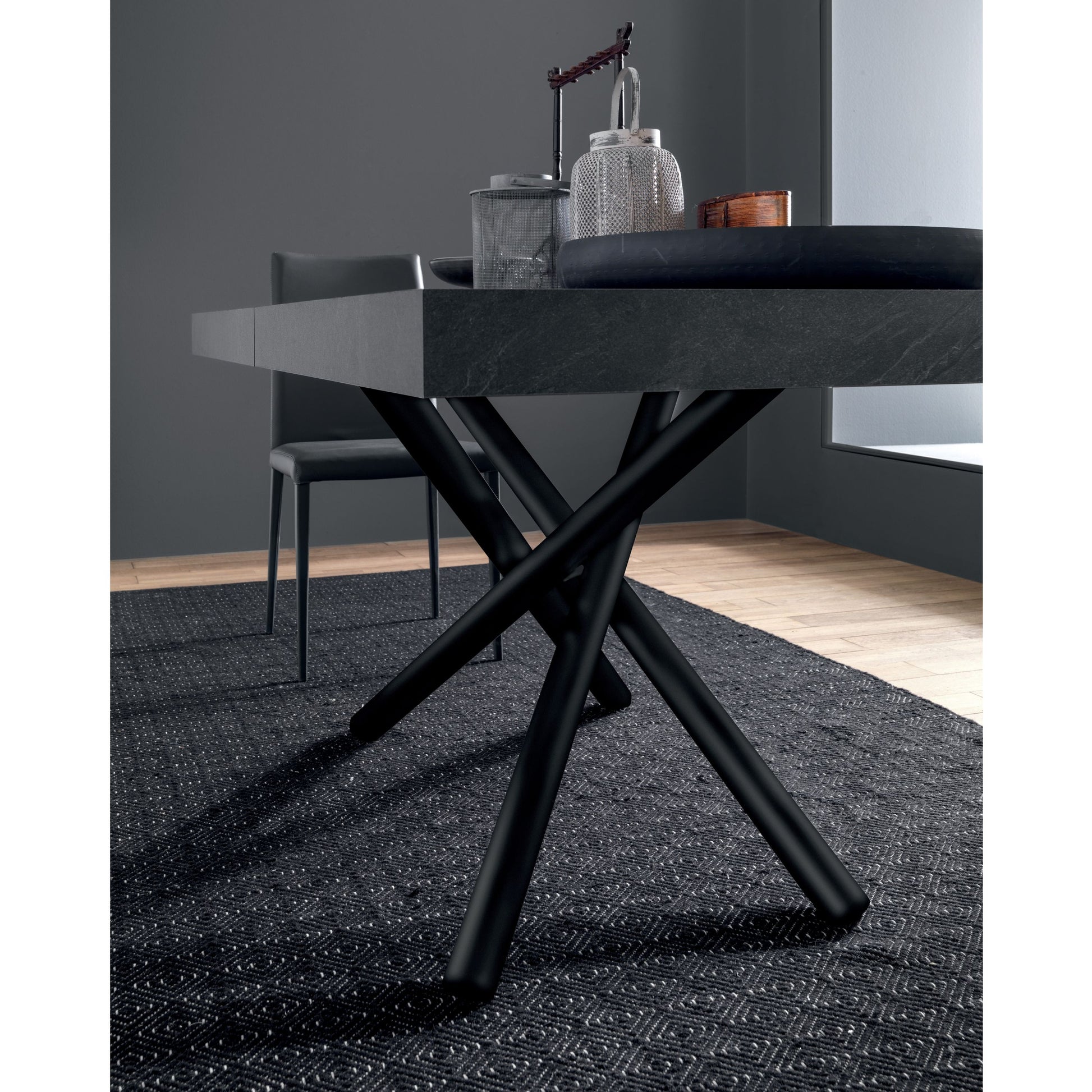 Altacom dining table with sculptural crossed metal base detail