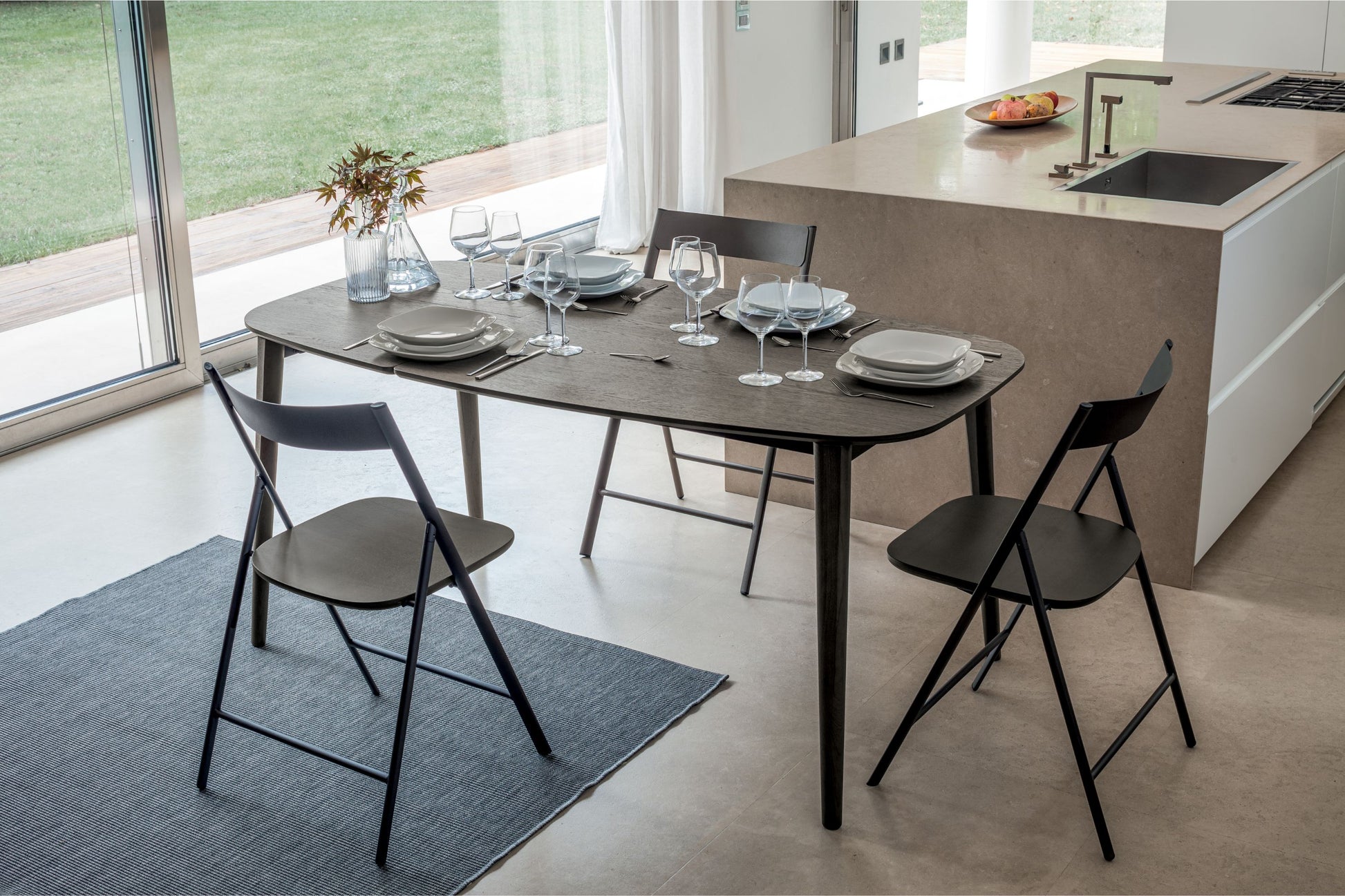 Altacom extendable dining table opened to seat six people with full table setting