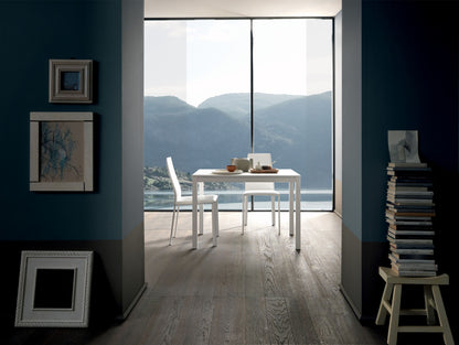 Altacom extendable table opened near window with mountain view modern home