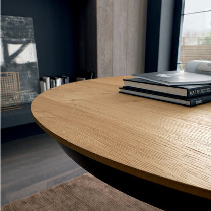 Wooden round table with books in a modern room setting