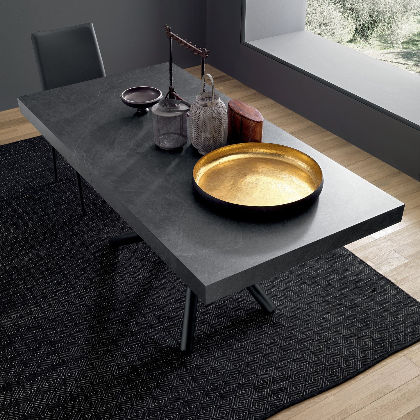 Top view of modern extendable dining table with ceramic surface and decor