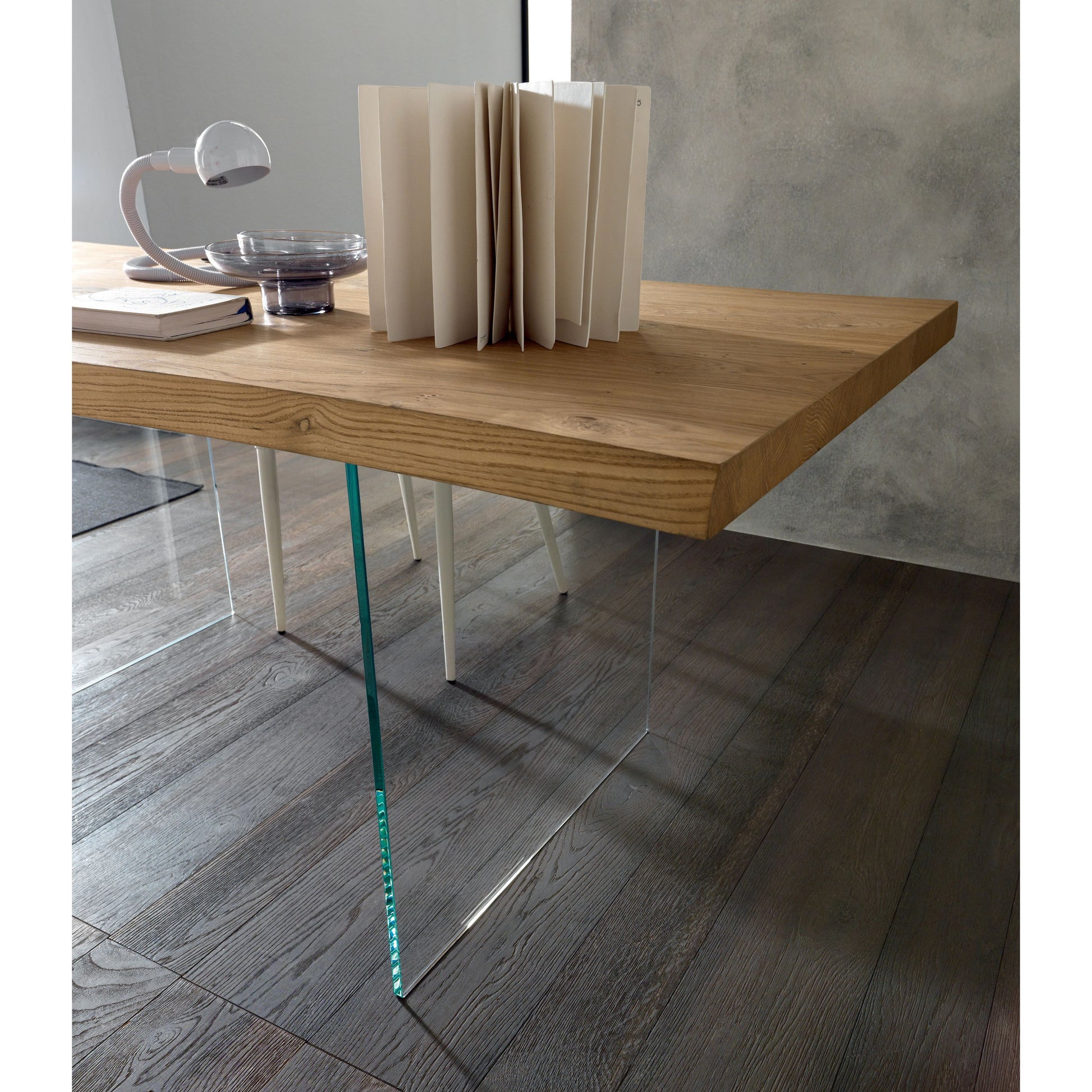 Close-up of Altacom oak table with transparent glass base and clean modern lines