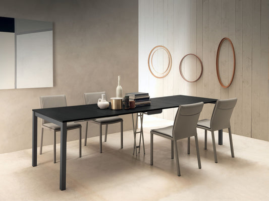 Altacom Quad extendable table fully extended in black wood finish with modern dining chairs