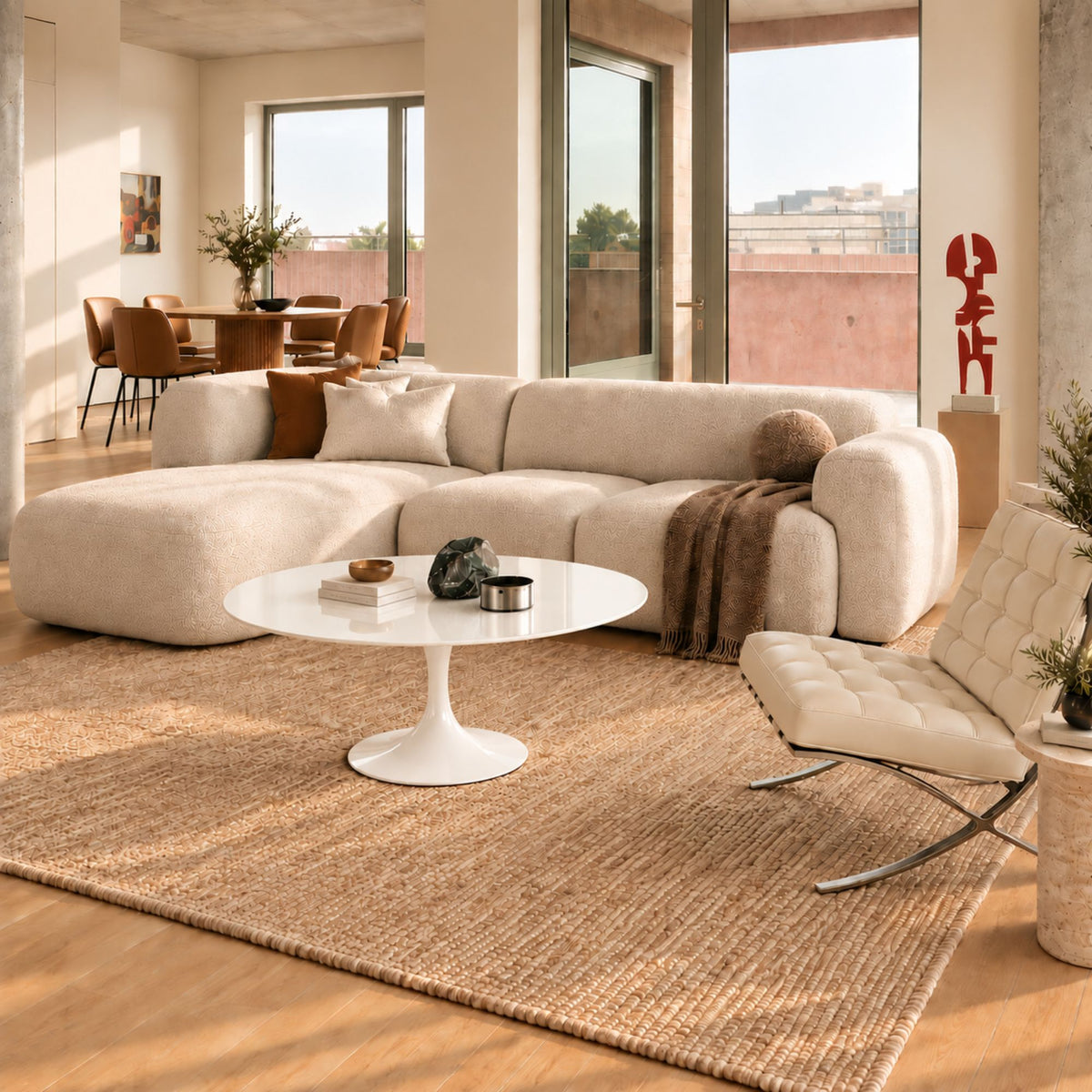 Arctic Gloss Tulip coffee table featuring a smooth glossy white liquid laminate tabletop paired with a matching glossy white tulip pedestal base. Styled in a contemporary living room with a curved cream sofa, designer lounge chair, woven rug, and warm natural daylight. A luxury Italian designer coffee table for modern, Scandinavian, and mid-century interiors.