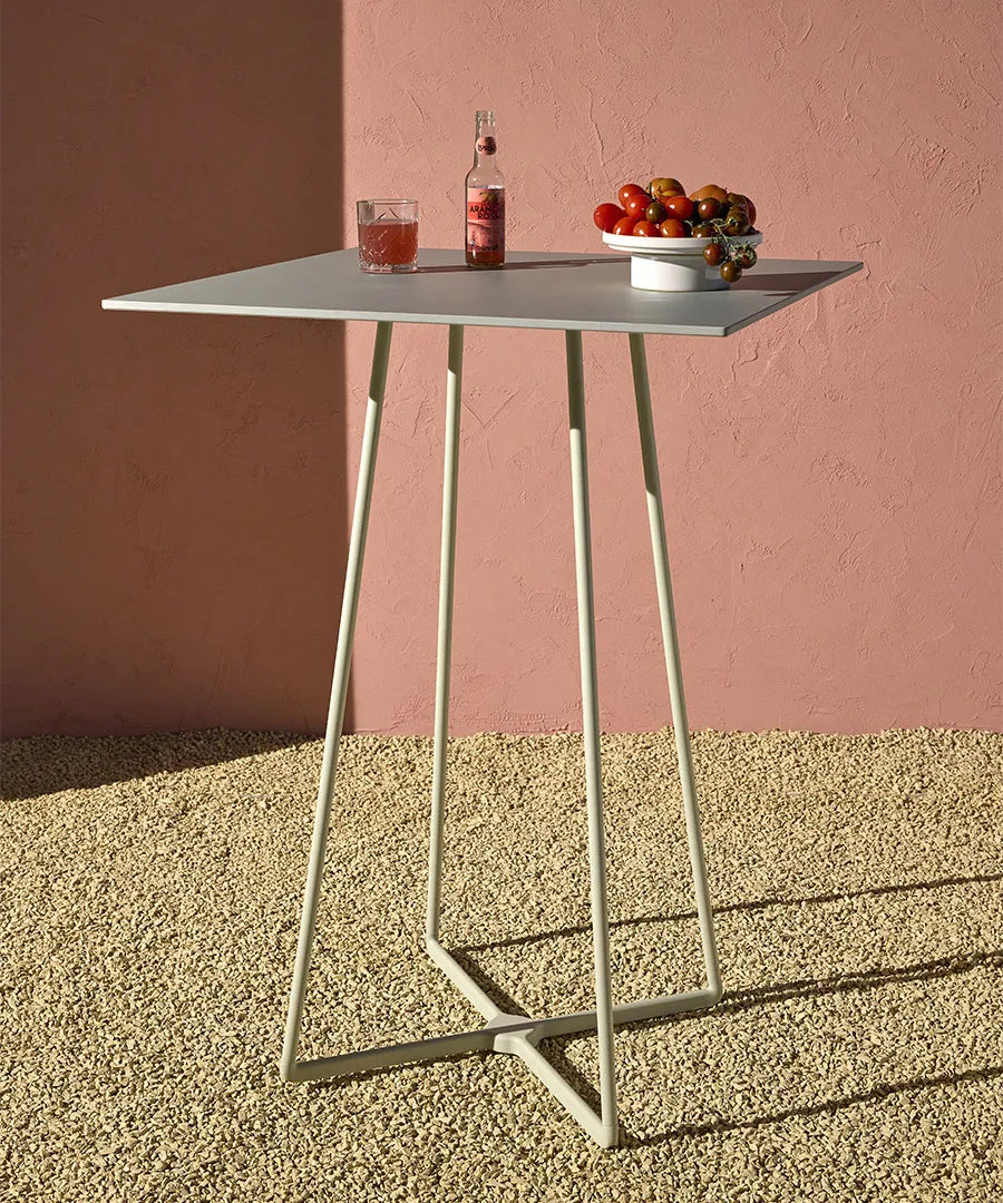 Front angled view of the S•CAB Atomo Bistro Table Base with a square bar-height tabletop and contemporary geometric metal base.