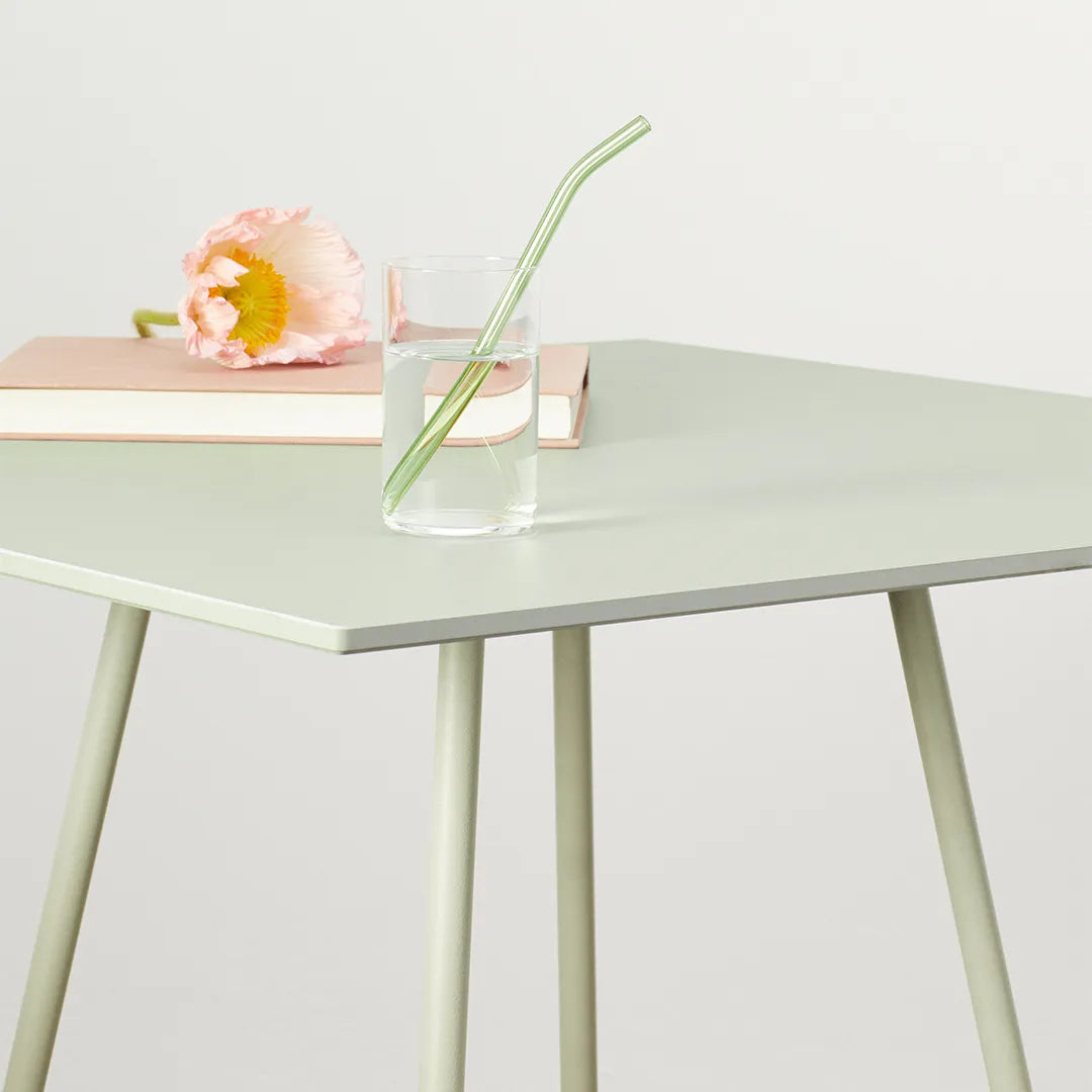Close-up of the S•CAB Atomo Bistro Table Base featuring a square tabletop with tapered metal legs in a contemporary minimalist design.