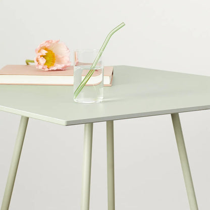 Close-up of the S•CAB Atomo Bistro Table Base featuring a square tabletop with tapered metal legs in a contemporary minimalist design.