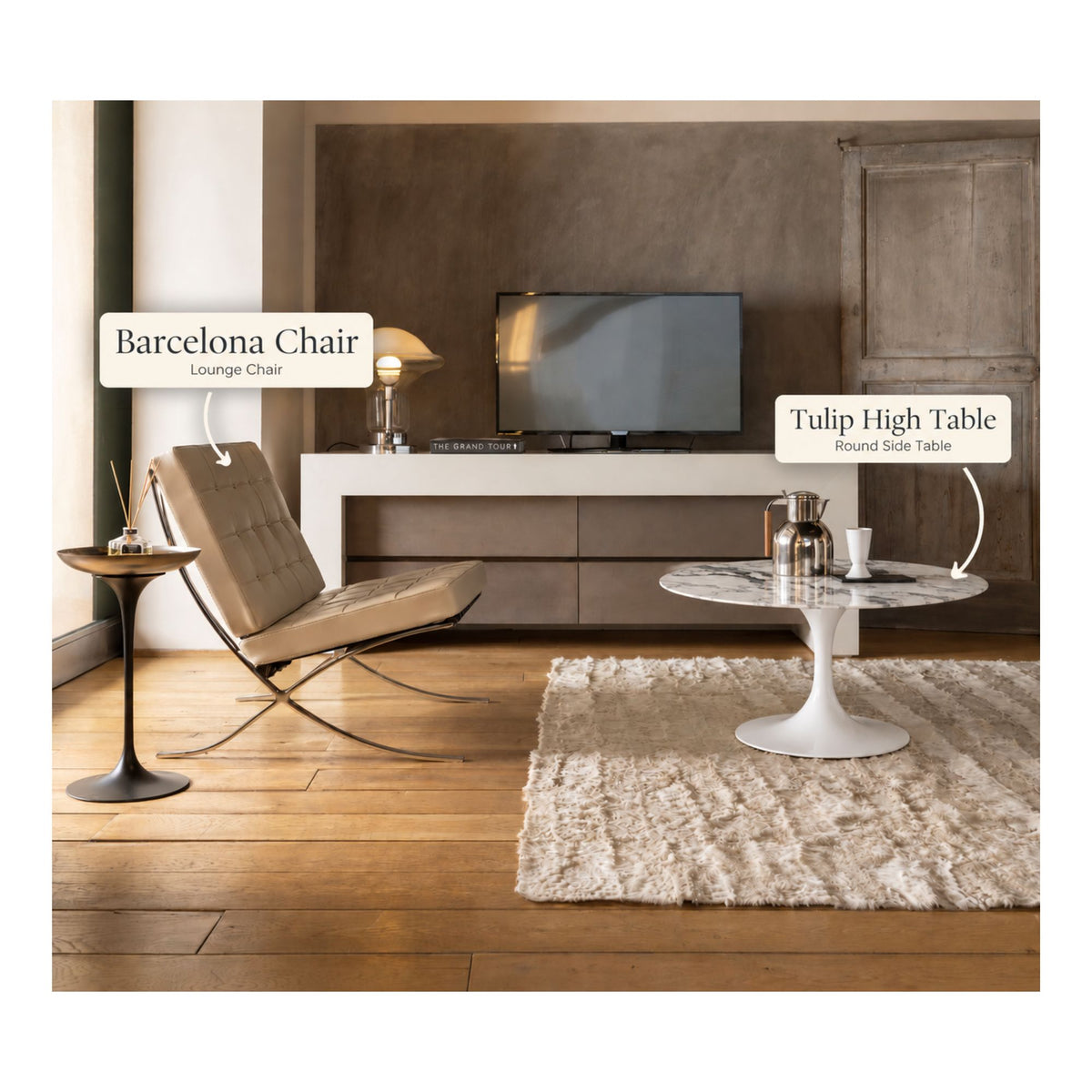 Barcelona lounge chair paired with a white marble Tulip high side table featuring a round marble top and white pedestal base in a contemporary living room with warm wood flooring.