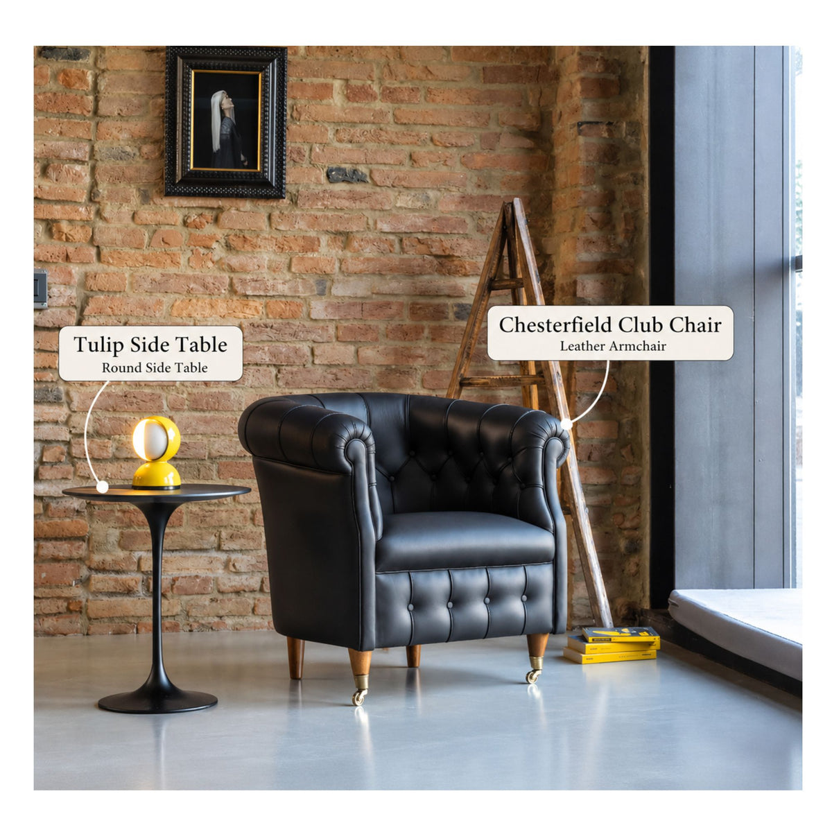 Black Chesterfield club chair paired with a black Tulip round side table in an industrial-style living room featuring exposed brick walls, a leather armchair, and a modern accent lamp.