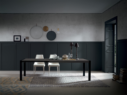 Compact black extendable dining table in modern interior with neutral tones