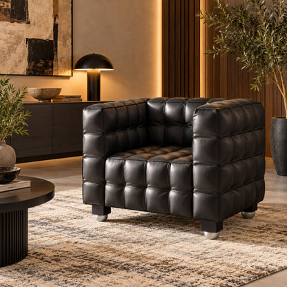 Black Kubus-style leather armchair with deep square tufted upholstery, geometric cube design and premium modern lounge seating for luxury living rooms, hotels and contemporary interiors.