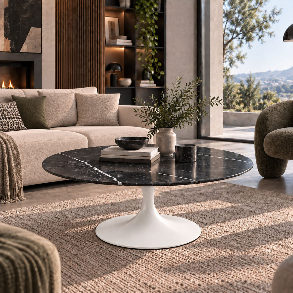 Black marble-effect oval Tulip coffee table with a white pedestal base styled in a luxury modern living room with contemporary décor and natural daylight.