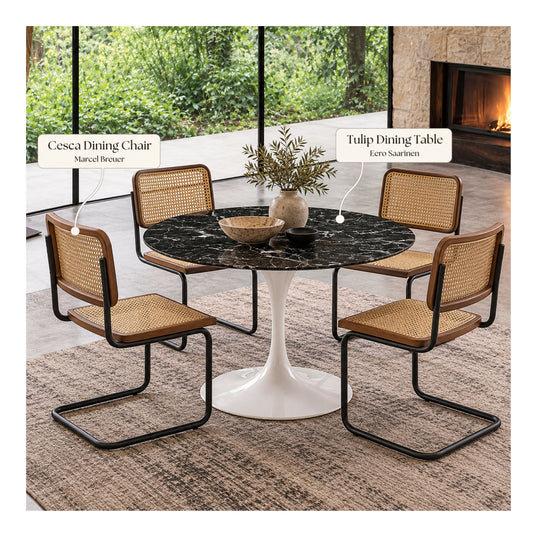 Black marble round Eero Saarinen Tulip dining table with a white pedestal base paired with four Cesca dining chairs featuring natural cane seats, walnut wood frames, and black cantilever steel legs in a modern dining room.
