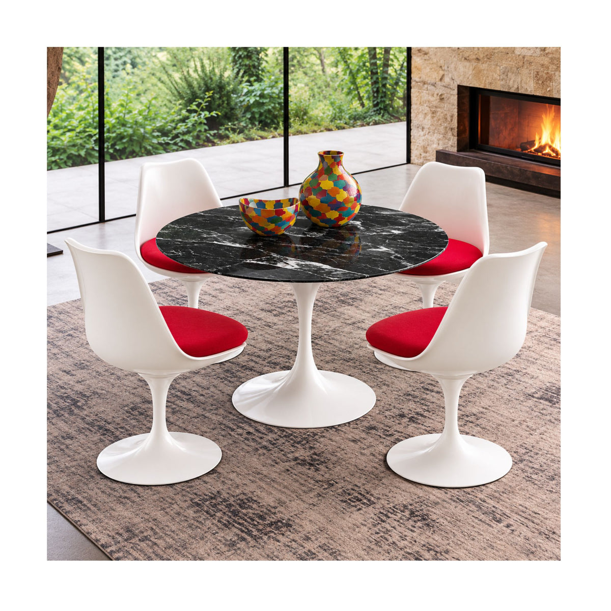 Round black marble Saarinen Tulip dining table paired with four white Tulip side chairs featuring red upholstered seat cushions in a contemporary mid-century modern dining room with a fireplace.
