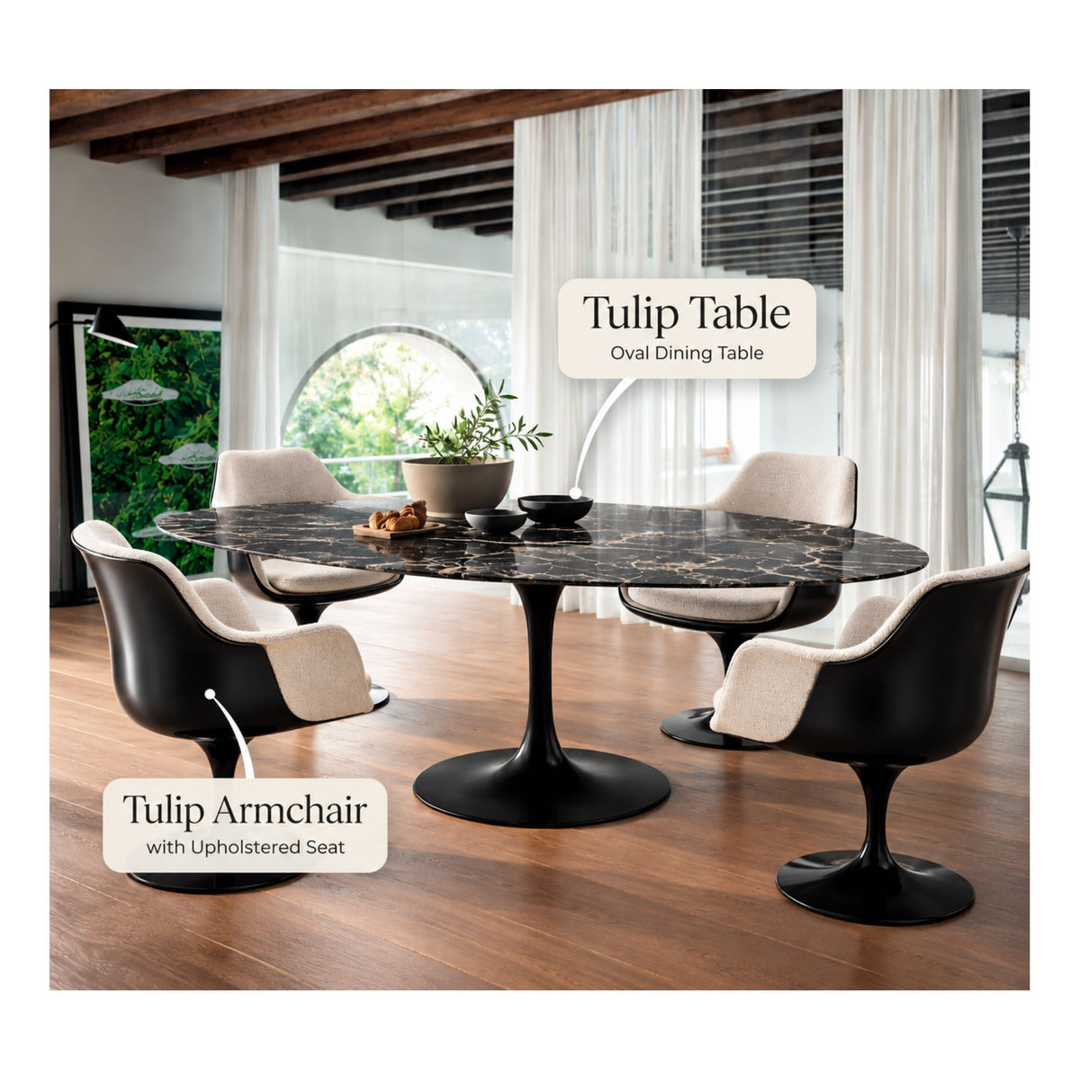 Black oval Tulip dining table with four black upholstered Tulip armchairs featuring cream fabric seat cushions in a contemporary dining room with a black pedestal base and modern interior.