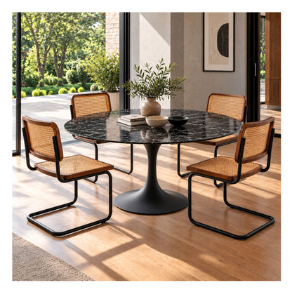 Black round Eero Saarinen Tulip dining table with a black pedestal base paired with four Cesca dining chairs featuring natural cane seats, walnut wood frames, and black cantilever steel frames in a contemporary dining room.