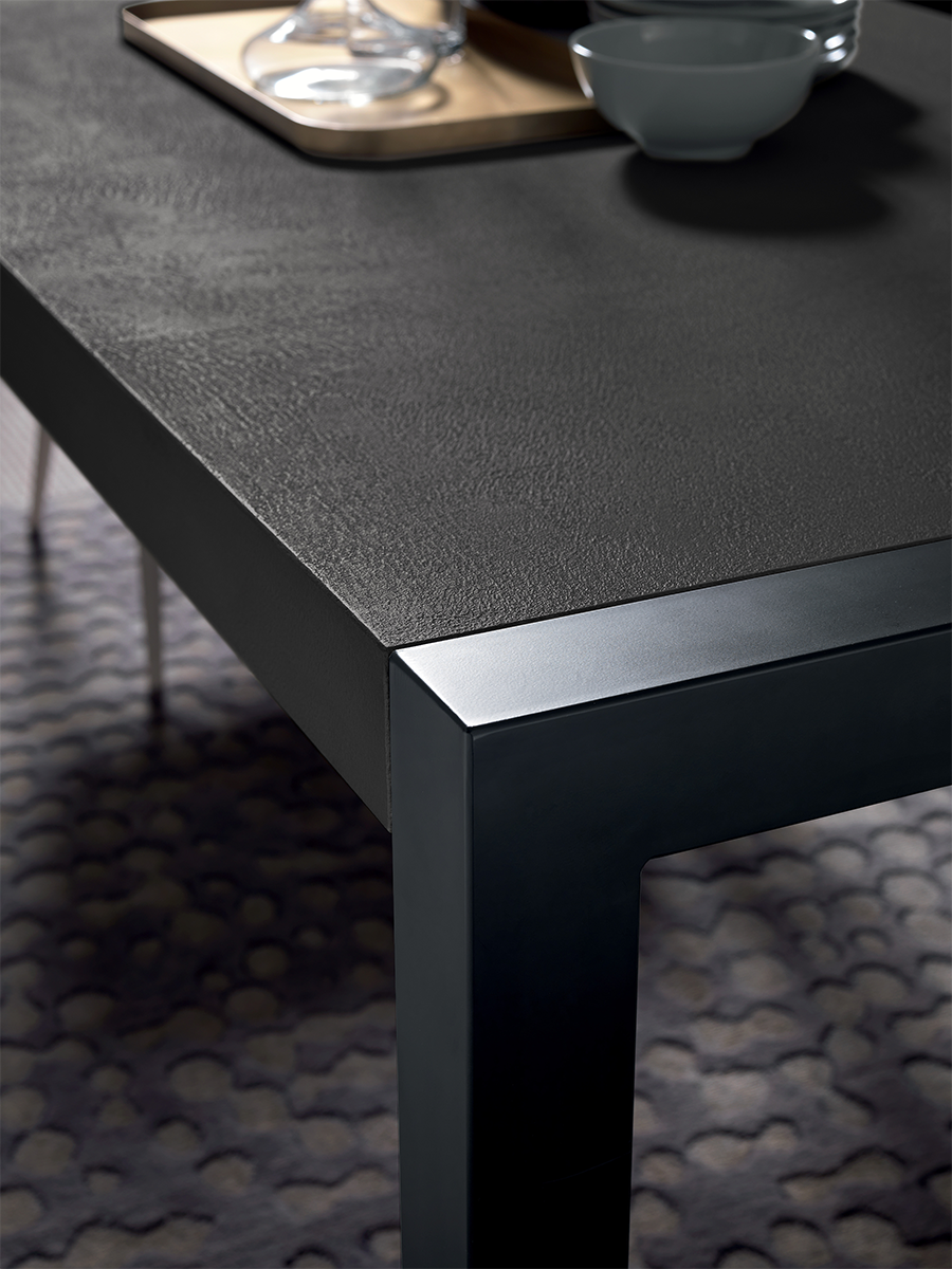Close-up of black textured dining table surface with modern finish