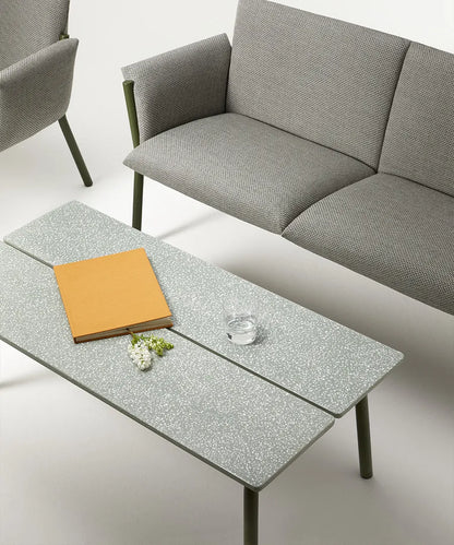 Close-up of the S•CAB Brezza outdoor coffee table featuring a textured glass tabletop alongside the matching Brezza outdoor sofa.